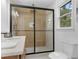 Modern bathroom features a large shower with glass doors, with new fixtures and vanity at 2014 Fence Rd, Dacula, GA 30019