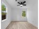 Light and airy bedroom with a modern ceiling fan, wood floors, and bright natural light at 2014 Fence Rd, Dacula, GA 30019