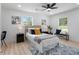 Stylish bedroom featuring a decorative rug, a bed with decorative pillows and two windows at 2014 Fence Rd, Dacula, GA 30019