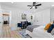 Bright and modern bedroom with a ceiling fan, light wood floors, and a white comforter at 2014 Fence Rd, Dacula, GA 30019