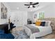 Bright and modern bedroom with a ceiling fan, light wood floors, and a white comforter at 2014 Fence Rd, Dacula, GA 30019