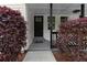 Inviting front entrance with a classic black door and decorative bushes on a well-manicured lawn at 2014 Fence Rd, Dacula, GA 30019