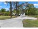 Charming house with fresh lawn surrounded by mature trees and a large concrete driveway at 2014 Fence Rd, Dacula, GA 30019
