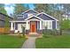 Charming home with a classic design, complemented by a brick walkway, lush landscaping, and a blue exterior at 206 Mead Rd, Decatur, GA 30030