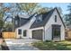 Charming home features a gray garage door, manicured lawn, and classic architectural details at 206 Mead Rd, Decatur, GA 30030