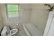 Clean bathroom features tub, toilet and large window for natural light at 3190 Cheru Ct, Decatur, GA 30034