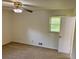 Bedroom showcasing carpet, a window with blinds, and a functional ceiling fan at 3190 Cheru Ct, Decatur, GA 30034