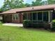 Back exterior with screened-in porch and manicured lawn at 3190 Cheru Ct, Decatur, GA 30034