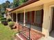Inviting front porch with brick accents and decorative wrought iron railing at 3190 Cheru Ct, Decatur, GA 30034
