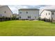 Spacious backyard featuring a well-maintained lawn, patio with seating and a black wooden fence at 5025 Bryce Ln, Cumming, GA 30040