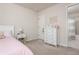 Cozy bedroom with white furniture, neutral walls, and attached bath at 5025 Bryce Ln, Cumming, GA 30040