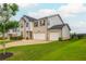 Two-story home with a two car garage, brick accents, an inviting front yard and driveway at 5025 Bryce Ln, Cumming, GA 30040