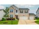 Charming two-story home with a brick facade, three-car garage, manicured lawn and inviting front door at 5025 Bryce Ln, Cumming, GA 30040