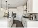 Modern kitchen with white cabinets, stainless steel appliances, an island and stylish pendant lighting at 5025 Bryce Ln, Cumming, GA 30040