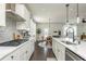 Beautiful kitchen island featuring stainless appliances and white cabinets which opens to a dining and living area at 5025 Bryce Ln, Cumming, GA 30040