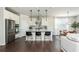 Bright open kitchen featuring white cabinets, a central island, stainless appliances and bar stool seating at 5025 Bryce Ln, Cumming, GA 30040
