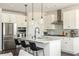 Modern kitchen featuring stainless appliances, quartz countertops, a central island, and bar seating at 5025 Bryce Ln, Cumming, GA 30040