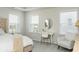 The room is a primary bedroom featuring a writing desk, bedside lamps and other decor at 5025 Bryce Ln, Cumming, GA 30040