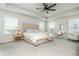 Spacious main bedroom featuring a large bed, two bedside tables, and a vanity area for a comfortable retreat at 5025 Bryce Ln, Cumming, GA 30040