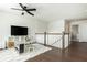 Loft with a TV, a play table and chairs, and a patterned rug providing space for entertainment and relaxation at 5025 Bryce Ln, Cumming, GA 30040