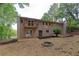 Expansive backyard with a fire pit, balcony, and lush greenery surrounding the property at 6010 Spalding Dr, Atlanta, GA 30350