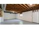Unfinished basement with exposed beams, painted walls and concrete flooring at 6010 Spalding Dr, Atlanta, GA 30350