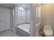 Bathroom features soaking tub, walk-in shower and commode at 6010 Spalding Dr, Atlanta, GA 30350