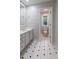 Bright bathroom featuring tiled floor, a vanity and a toilet in separate room at 6010 Spalding Dr, Atlanta, GA 30350