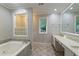 Bathroom boasts a soaking tub and double sink vanity providing a luxurious and functional space at 6010 Spalding Dr, Atlanta, GA 30350