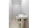 Half bathroom featuring a pedestal sink, tiled floor, and modern fixtures at 6010 Spalding Dr, Atlanta, GA 30350