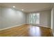 Bright bedroom with hardwood floors, recessed lighting, and a large window with a wooded view at 6010 Spalding Dr, Atlanta, GA 30350