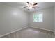 Comfortable bedroom with neutral carpet, a window, and a ceiling fan, ideal for rest and relaxation at 6010 Spalding Dr, Atlanta, GA 30350