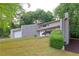Stunning two-story home showcasing a well-manicured lawn and inviting curb appeal in a serene, wooded setting at 6010 Spalding Dr, Atlanta, GA 30350