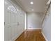 Inviting foyer with hardwood floors, a staircase, and decorative glass on the entry closet at 6010 Spalding Dr, Atlanta, GA 30350