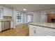 Bright kitchen featuring stainless steel appliances, a breakfast bar, and a view of the living room at 6010 Spalding Dr, Atlanta, GA 30350