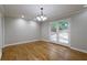 Open living room with a chandelier, hardwood floors, and glass doors leading to the outside at 6010 Spalding Dr, Atlanta, GA 30350