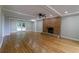 Spacious living room with hardwood floors, brick fireplace, recessed lighting, and natural light at 6010 Spalding Dr, Atlanta, GA 30350