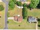 Aerial view of a home with a well-maintained lawn, treed boundaries and driveway leading to a two-car garage at 710 Freeman Dr, Covington, GA 30016