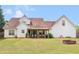 Spacious backyard view featuring a covered patio attached to a two-story home on a sunny day at 710 Freeman Dr, Covington, GA 30016