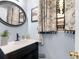 Bathroom featuring a vanity with a black faucet, stylish mirror, and floral curtains at 710 Freeman Dr, Covington, GA 30016
