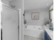 Bright bathroom featuring a shower and separate tub at 710 Freeman Dr, Covington, GA 30016