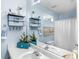 Bright bathroom with a large mirror, blue walls, and modern fixtures above the dual sinks at 710 Freeman Dr, Covington, GA 30016