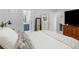Bedroom with a view to the bathroom, a large bed, and a mirrored dresser at 710 Freeman Dr, Covington, GA 30016