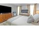 Bedroom featuring neutral walls, a large TV, and a queen bed with a throw blanket at 710 Freeman Dr, Covington, GA 30016