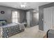 Spacious bedroom with a ceiling fan, a comfortable bed, and neutral carpet flooring at 710 Freeman Dr, Covington, GA 30016