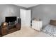 Bedroom with a TV, a dresser, and a comfortable bed, creating a cozy atmosphere at 710 Freeman Dr, Covington, GA 30016