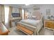Bedroom with a large bed, fireplace, and neutral decor at 710 Freeman Dr, Covington, GA 30016