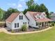 Two story home featuring an attached two-car garage and large, covered front porch with wood support beams at 710 Freeman Dr, Covington, GA 30016