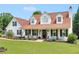 Charming two-story home featuring a welcoming front porch and well-maintained landscaping with black shutters and a lush green lawn at 710 Freeman Dr, Covington, GA 30016