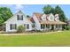 Charming two-story home featuring a welcoming front porch and well-maintained landscaping with black shutters and a lush green lawn at 710 Freeman Dr, Covington, GA 30016